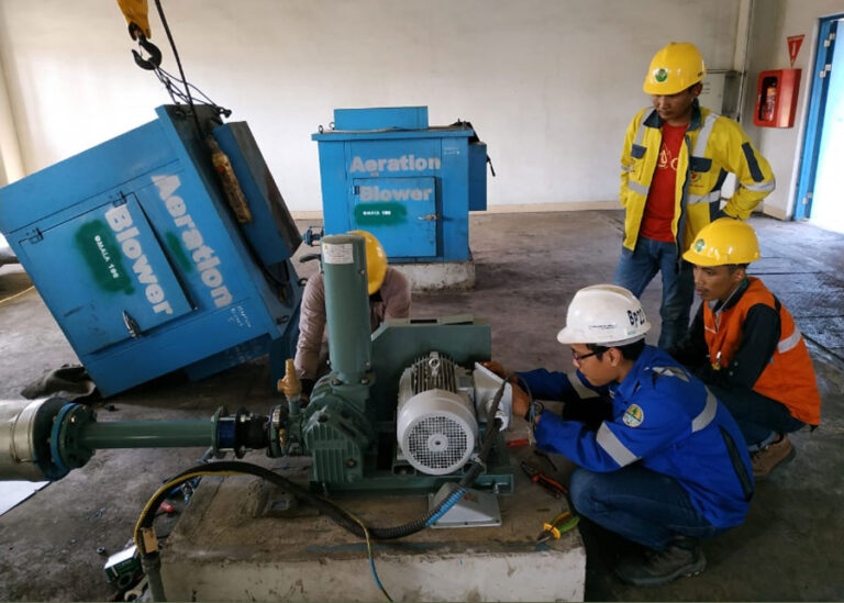 Teknisi melakukan pemeliharaan sistem filter WTP industri untuk mengatasi penyumbatan tanpa menghentikan proses produksi.